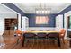 Elegant dining area with blue walls, modern light fixture, and stylish seating, perfect for gatherings and meals at 5729 Brookstone Nw Walk, Acworth, GA 30101