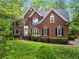 Traditional two-story brick home featuring a manicured lawn and symmetrical design at 5729 Brookstone Nw Walk, Acworth, GA 30101