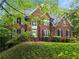 Traditional brick home with lush landscaping, a manicured lawn, and a grand front facade at 5729 Brookstone Nw Walk, Acworth, GA 30101