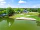 Overhead view of a pond, golf course, and clubhouse on a sunny day at 5729 Brookstone Nw Walk, Acworth, GA 30101
