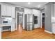 Modern kitchen with stainless steel appliances, white cabinetry, granite countertops, and hardwood flooring at 5729 Brookstone Nw Walk, Acworth, GA 30101