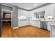Bright kitchen with stainless steel appliances, white cabinets, and hardwood floors, perfect for cooking and entertaining at 5729 Brookstone Nw Walk, Acworth, GA 30101
