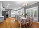 Bright kitchen with white cabinetry, hardwood floors, a large island, and an adjacent dining area at 5729 Brookstone Nw Walk, Acworth, GA 30101