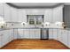 Well-lit kitchen featuring white cabinets, granite counters, stainless steel appliances, and hardwood floors at 5729 Brookstone Nw Walk, Acworth, GA 30101