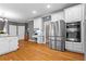 Well-equipped kitchen featuring white cabinets, stainless steel appliances, and a convenient built-in desk area at 5729 Brookstone Nw Walk, Acworth, GA 30101