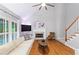 Inviting living room with high ceilings, fireplace, plantation shutters, and hardwood floors, creating an elegant and comfortable space at 5729 Brookstone Nw Walk, Acworth, GA 30101
