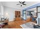 Stylish home office with hardwood floors, a ceiling fan, built-in shelves, and sliding barn doors to the dining room at 5729 Brookstone Nw Walk, Acworth, GA 30101
