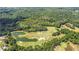 An aerial view of the golf course and ponds surrounded by a lush green forest at 114 Montgomery Ln, Villa Rica, GA 30180
