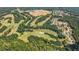Expansive aerial shot of the golf course surrounded by mature trees and residential areas at 114 Montgomery Ln, Villa Rica, GA 30180