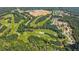 Expansive aerial shot of the golf course surrounded by mature trees and residential areas at 114 Montgomery Ln, Villa Rica, GA 30180
