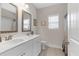 Well-lit bathroom featuring double sinks, vanity, and tile flooring at 114 Montgomery Ln, Villa Rica, GA 30180
