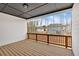 A spacious outdoor deck with wooden flooring and railings offers a beautiful view of the surrounding neighborhood at 114 Montgomery Ln, Villa Rica, GA 30180