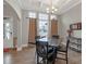 This dining room features a dark wood table set, decorative chandelier, and large windows at 114 Montgomery Ln, Villa Rica, GA 30180