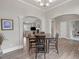Open-concept dining room showcasing a dark wood table set in a naturally lit space at 114 Montgomery Ln, Villa Rica, GA 30180