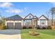 Charming home with a well-manicured lawn, a two-car garage, and appealing architectural details at 114 Montgomery Ln, Villa Rica, GA 30180