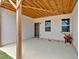 A covered patio area with concrete flooring, perfect for outdoor seating and relaxation, with a door to the backyard at 114 Montgomery Ln, Villa Rica, GA 30180