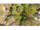 An aerial view showcases a mature lot surrounded by lush trees, its boundaries marked in red at 362 Battle Woods Nw Trl, Marietta, GA 30064