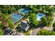 Aerial view features community tennis courts and pool, nestled among mature trees at 362 Battle Woods Nw Trl, Marietta, GA 30064