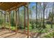 Covered deck with wood posts overlooks a lush, wooded backyard at 362 Battle Woods Nw Trl, Marietta, GA 30064