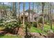 Home with a deck is surrounded by a lush backyard with mature trees at 362 Battle Woods Nw Trl, Marietta, GA 30064