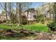 The home has a backyard with trees and lush green landscaping at 362 Battle Woods Nw Trl, Marietta, GA 30064