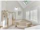 Bright bathroom features a soaking tub, glass shower enclosure, and plantation shutters at 362 Battle Woods Nw Trl, Marietta, GA 30064