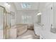 Bright bathroom featuring a skylight, soaking tub, and a double vanity at 362 Battle Woods Nw Trl, Marietta, GA 30064