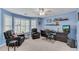 Well-lit blue bedroom with two leather recliners and an office space at 362 Battle Woods Nw Trl, Marietta, GA 30064