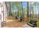 Elevated deck with barbeque and seating overlooking a beautifully wooded backyard at 362 Battle Woods Nw Trl, Marietta, GA 30064