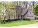 Beautifully landscaped two-story home with a well-manicured lawn, trees, and an attached two-car garage at 362 Battle Woods Nw Trl, Marietta, GA 30064