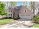 Charming two-story home with a well-manicured lawn, beautiful landscaping, and a driveway leading to a two-car garage at 362 Battle Woods Nw Trl, Marietta, GA 30064