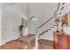Bright foyer features hardwood floors, a staircase, a decorative rug, and a view of the front door and sidelights at 362 Battle Woods Nw Trl, Marietta, GA 30064
