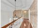 Hallway with hardwood floors and decorative floral wallpaper adjacent to the staircase at 362 Battle Woods Nw Trl, Marietta, GA 30064