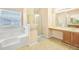 Bright bathroom featuring a soaking tub, walk-in shower, vanity, neutral paint, tile floor, and natural light at 3642 Sunbridge Dr, Snellville, GA 30039