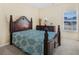 Cozy bedroom featuring a wooden bed frame, dresser, soft lighting, and a large window at 3642 Sunbridge Dr, Snellville, GA 30039