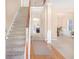 Bright foyer with staircase and hardwood floors, leading to the living spaces in the home at 3642 Sunbridge Dr, Snellville, GA 30039