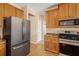 Kitchen boasts stainless steel appliances, including refrigerator and stove, plus tile flooring and ample cabinet space at 3642 Sunbridge Dr, Snellville, GA 30039