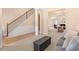 Open-concept living room with staircase and entryways, highlighted by modern decor and neutral tones at 3642 Sunbridge Dr, Snellville, GA 30039