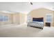 Spacious main bedroom with neutral carpeting, high ceilings, ensuite bathroom, and large windows at 3642 Sunbridge Dr, Snellville, GA 30039