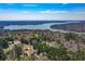 Scenic aerial view of a lake surrounded by lush, green forests and luxury homes at 507 Anthony Pl, Canton, GA 30114