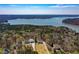 An aerial view of homes near the lake surrounded by a beautiful forest and neighborhood at 507 Anthony Pl, Canton, GA 30114