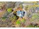 Aerial view of house with deck surrounded by mature trees and foliage at 507 Anthony Pl, Canton, GA 30114