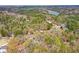 This aerial showcases this home's location amongst many mature trees and near a lake at 507 Anthony Pl, Canton, GA 30114