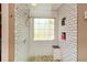 Beautiful bathroom featuring a tiled shower with a built-in bench and shower caddy at 507 Anthony Pl, Canton, GA 30114