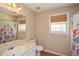Bright bathroom with a single vanity and a shower with colorful shower curtains at 507 Anthony Pl, Canton, GA 30114