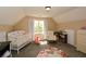 Well-lit Bedroom with a crib, soft rug, and cozy reading nook at 507 Anthony Pl, Canton, GA 30114