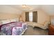 Cozy bedroom featuring a bed, chaise lounge, and natural light at 507 Anthony Pl, Canton, GA 30114