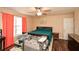 Comfortable bedroom featuring ceiling fan, wooden floors, and ample natural light at 507 Anthony Pl, Canton, GA 30114