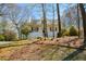 Charming home featuring a covered front porch and a beautifully landscaped front yard with mature trees at 507 Anthony Pl, Canton, GA 30114