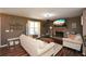 Cozy living room with a stone fireplace, ceiling fan, and hardwood floors at 507 Anthony Pl, Canton, GA 30114